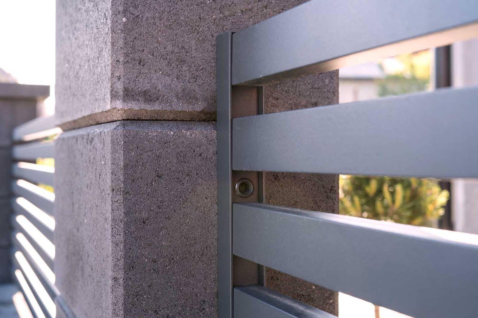 Detail uchycení hliníkového plotu LAMARK k betonovému sloupku | Motiv Avila | Šedá antracitová barva | Betonové sloupky