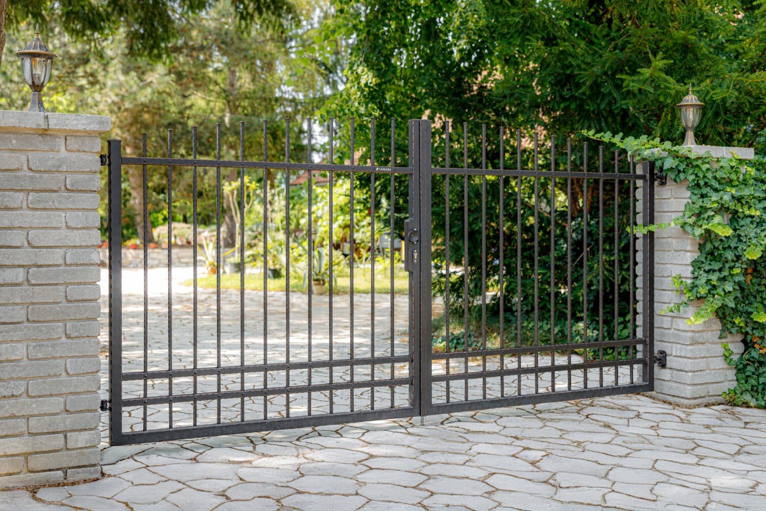 Kovaná otočná brána dvoukřídlá LAMARK s ručním otevíráním | Motiv Detroit | Černá kovářská barva | Měděná patina | Svařované s nýty | Oklepávané provedení | Okované konce | Zděné sloupky